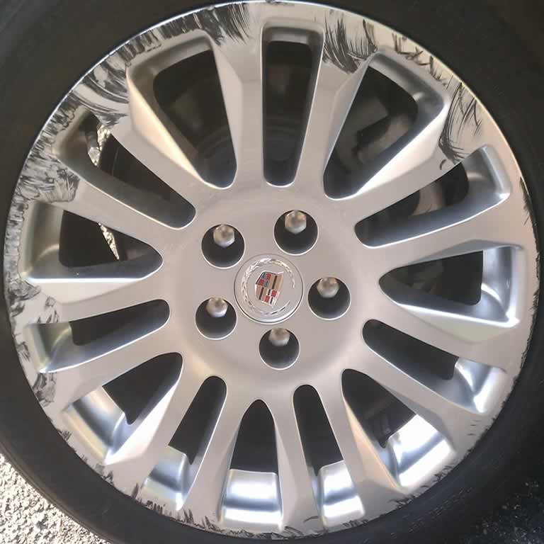 a badly scuffed alloy wheel